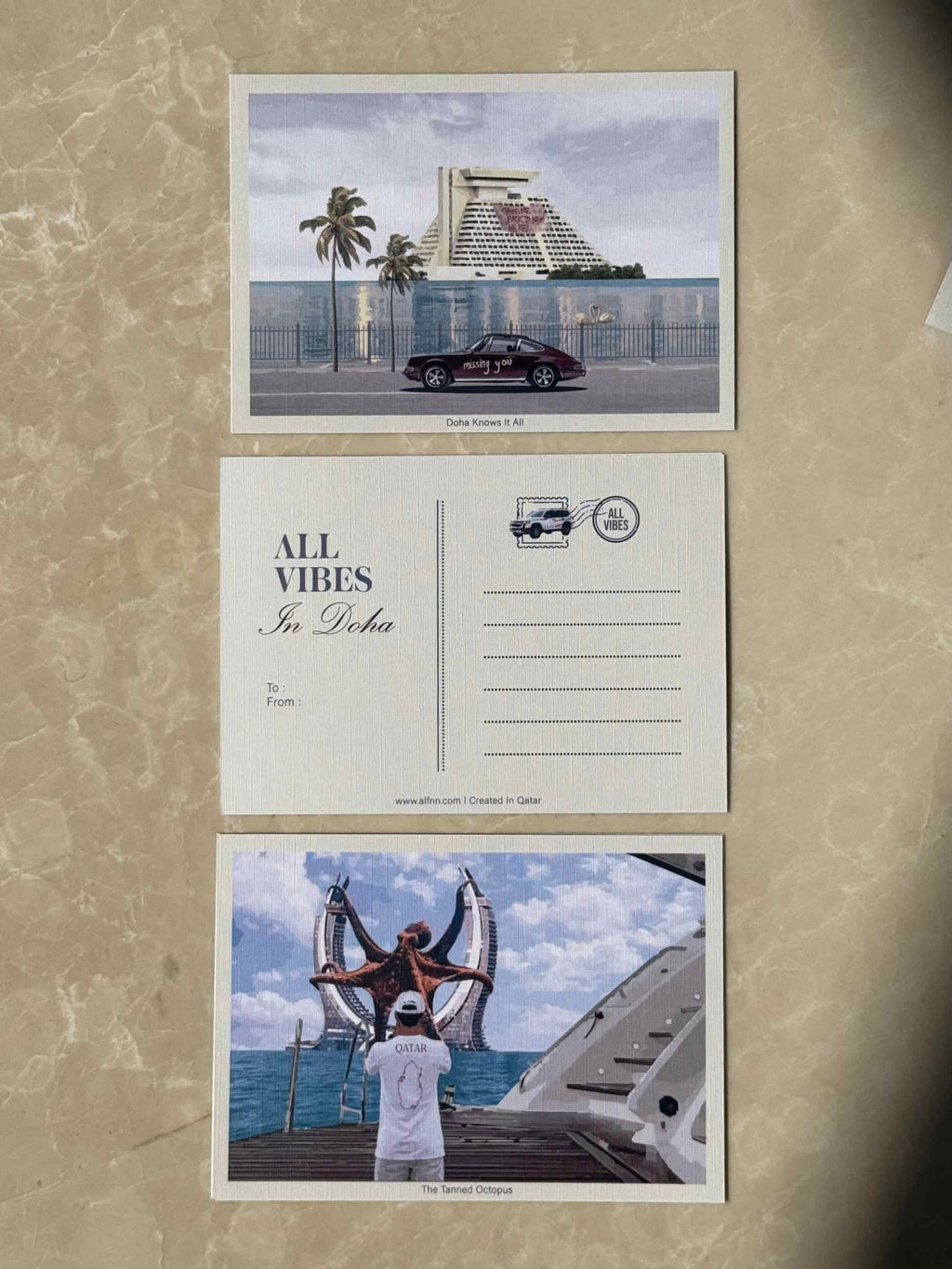 Doha Knows It All postcard - vintage Porsche by Sheraton Doha hotel
The Tanned Octopus postcard - Katara Towers Doha with octopus 