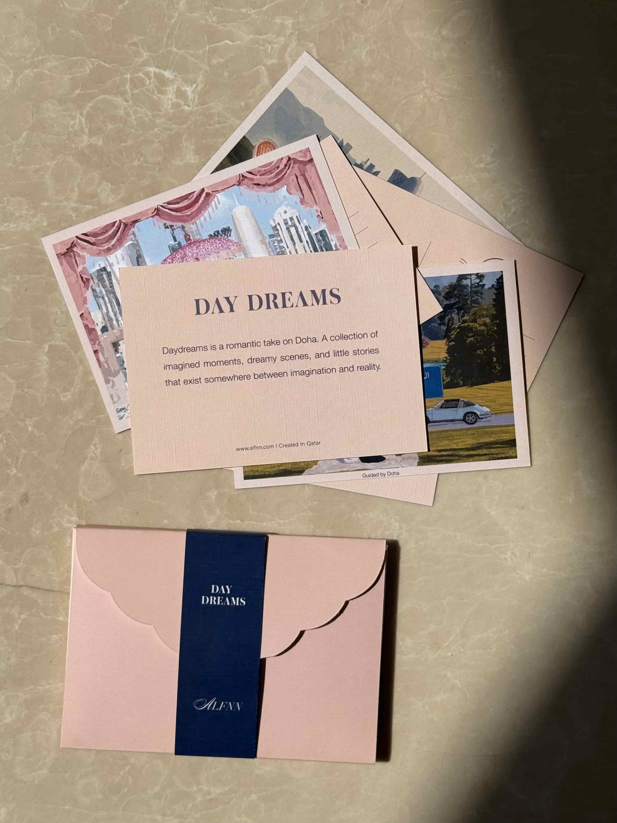 A set of printed postcards and matching envelope. The postcard Set is DAY DREAMS from Qatar pale blush pink.

