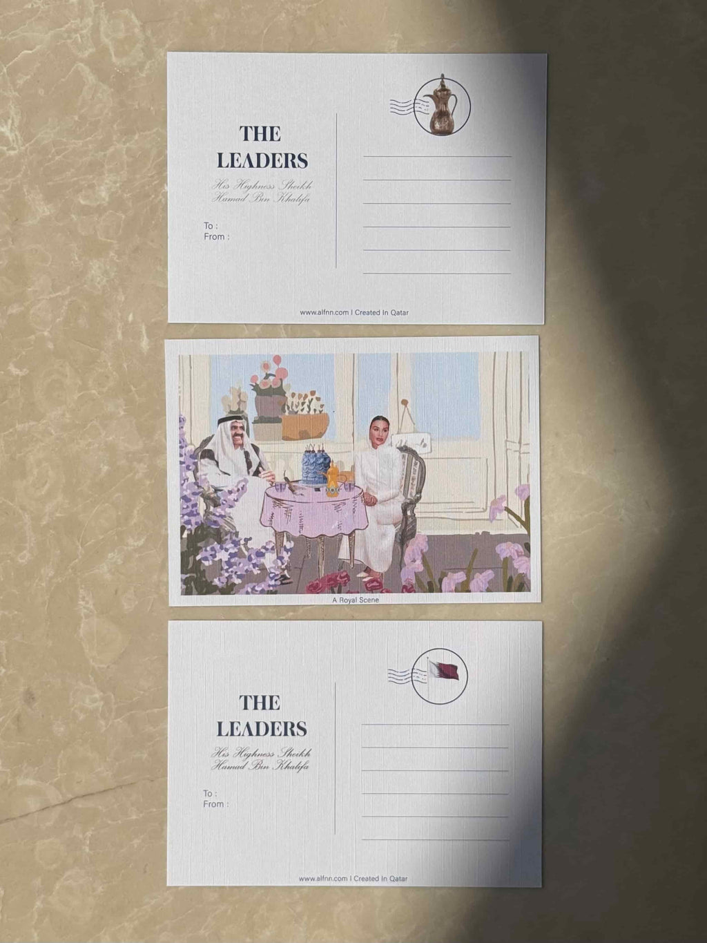 A Royal Scene postcard -Sheikh Hamad and Sheikha Moza at a floral table setting with cake, The Leaders collection