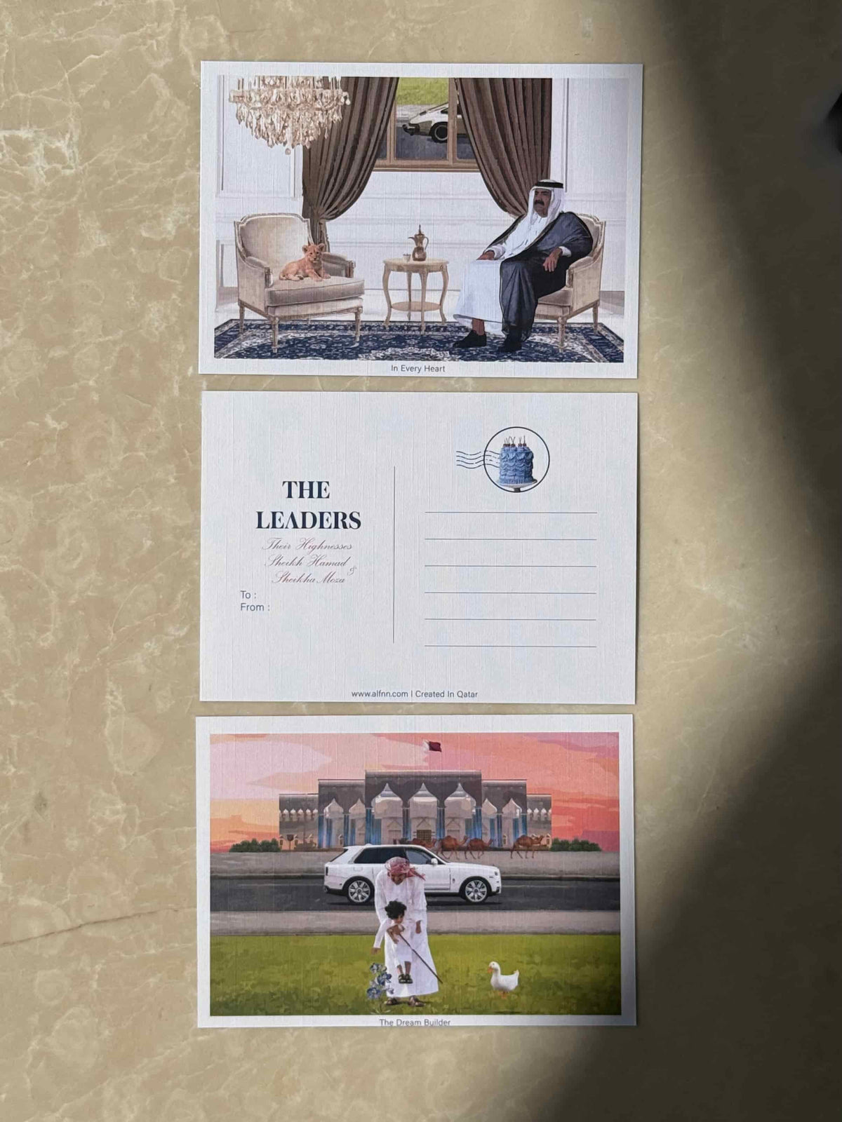 In Every Heart postcard -Sheikh Hamad seated with lion cub and traditional coffee pot, The Leaders collection

The Dream Builder postcard - Sheikh Hamad with a child, his car and Diwan al amiri at sunset