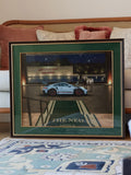 AL FNN "At the Porte-Cochère" framed artwork - Porsche GT3 RS, horse, and falcon at The Ned Doha entrance, green and gold frame