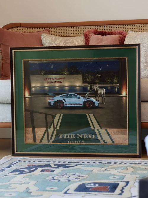 AL FNN "At the Porte-Cochère" framed artwork - Porsche GT3 RS, horse, and falcon at The Ned Doha entrance, green and gold frame